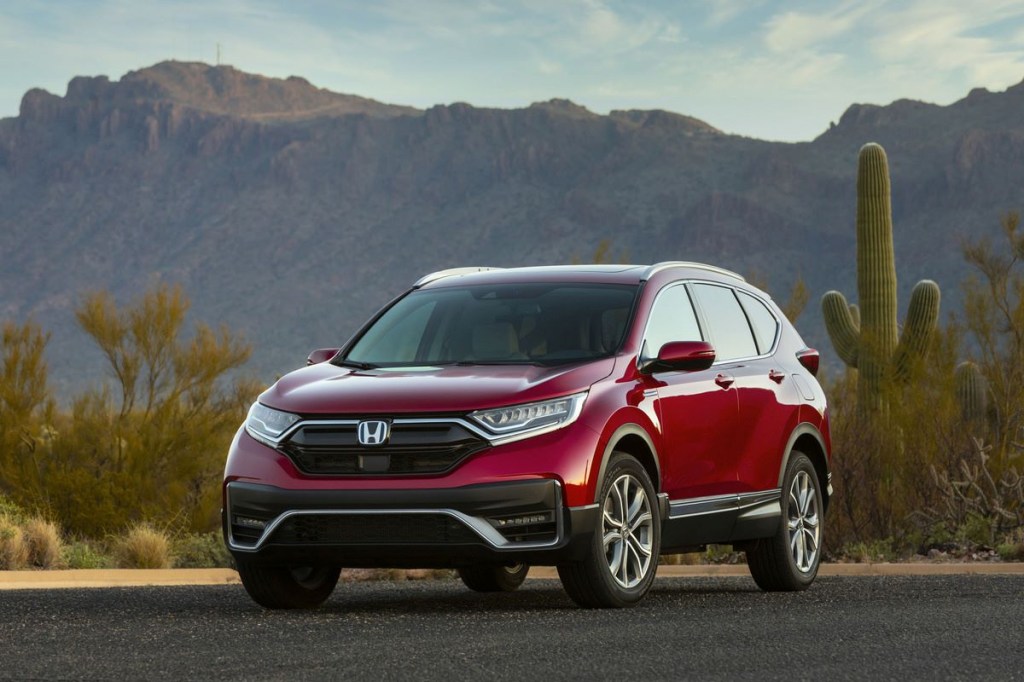 A red 2022 Honda CR-V on the road in a desert environment.
