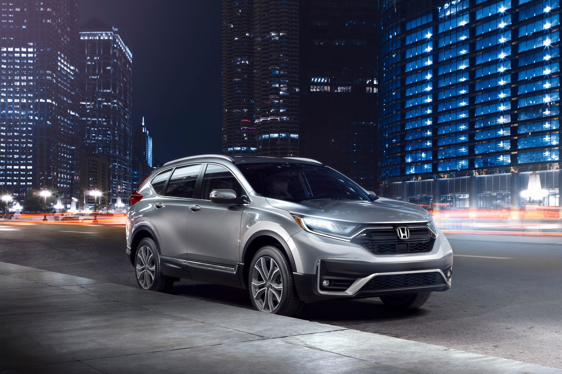 2022 Honda CR-V Touring compact SUV in silver gray parked in the city at night