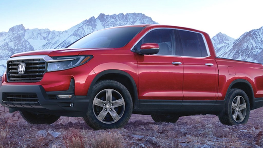 A red Honda Ridgeline shows off its styling as a mid-size truck.