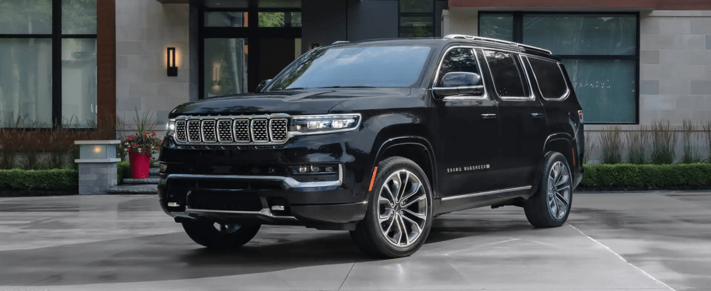 The 2022 Jeep Grand Wagoneer full-size luxury SUV model parked on a slate plaza