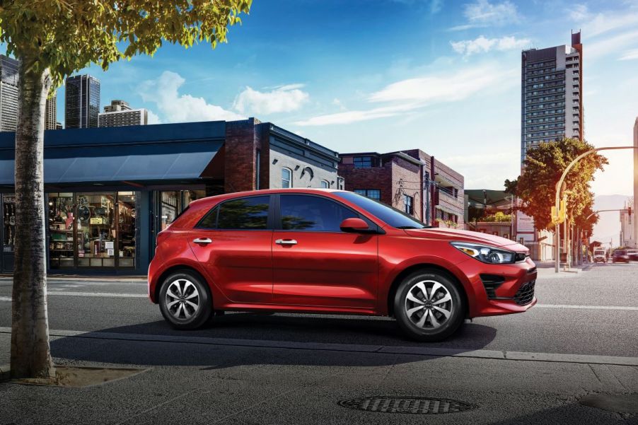 A red 2022 Kia Rio 5-Door in a downtown environment.