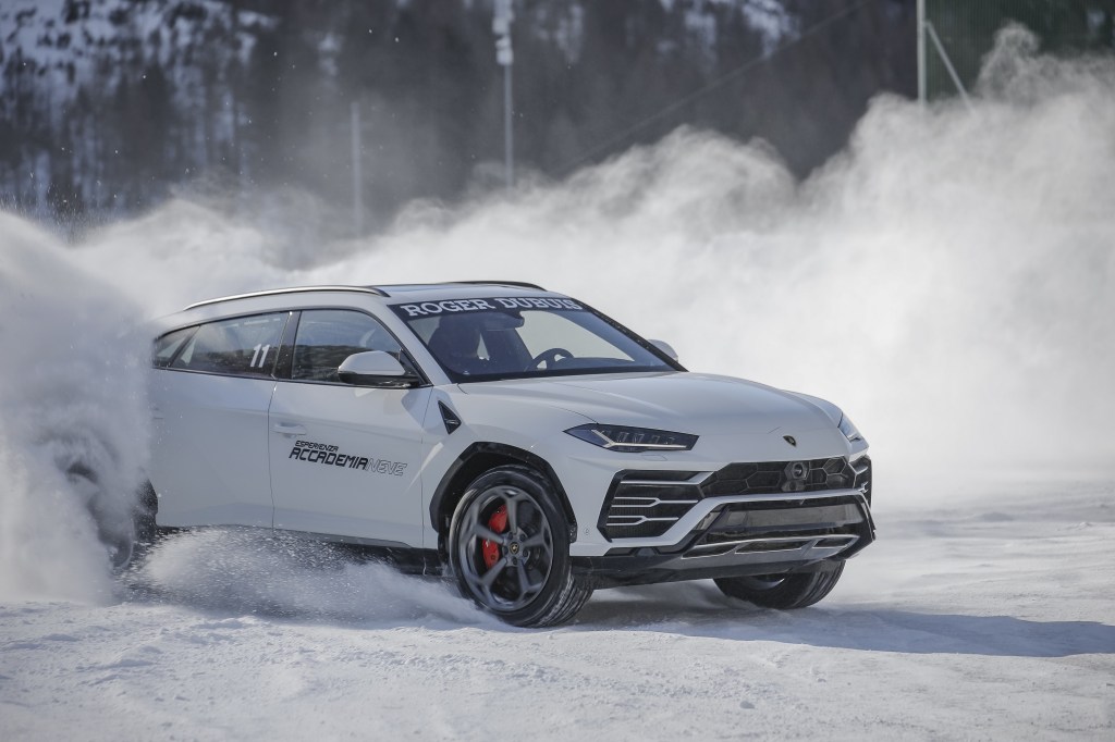 A white 2022 Lamborghini Urus sliding through the snow
