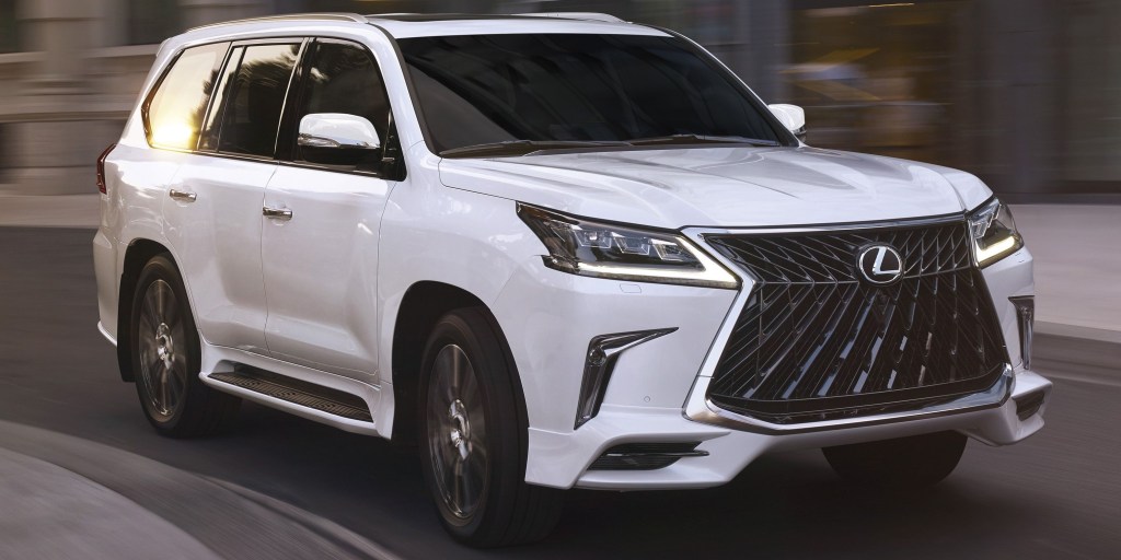 White 2022 Lexus GX luxury SUV driving on the road. This is the most reliable luxury SUV in the market according to Consumer Reports.