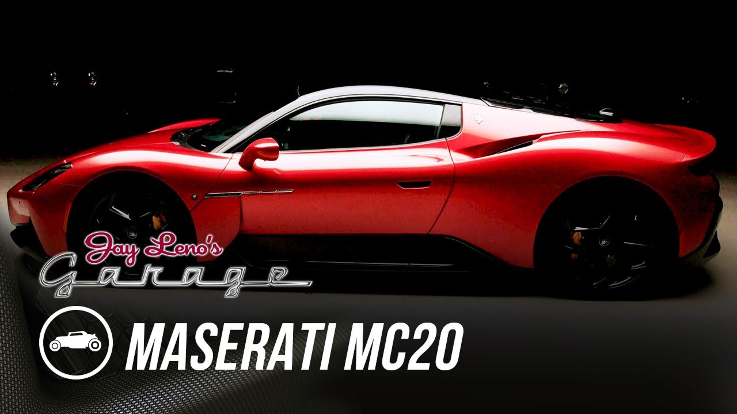 The side view of a red-and-black 2022 Maserati MC20 in Jay Leno's garage