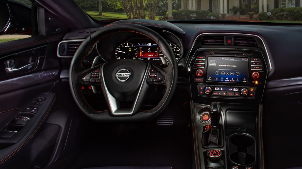 An interior shot showing the steering wheel and center display of the 2022 Nissan Maxima SR