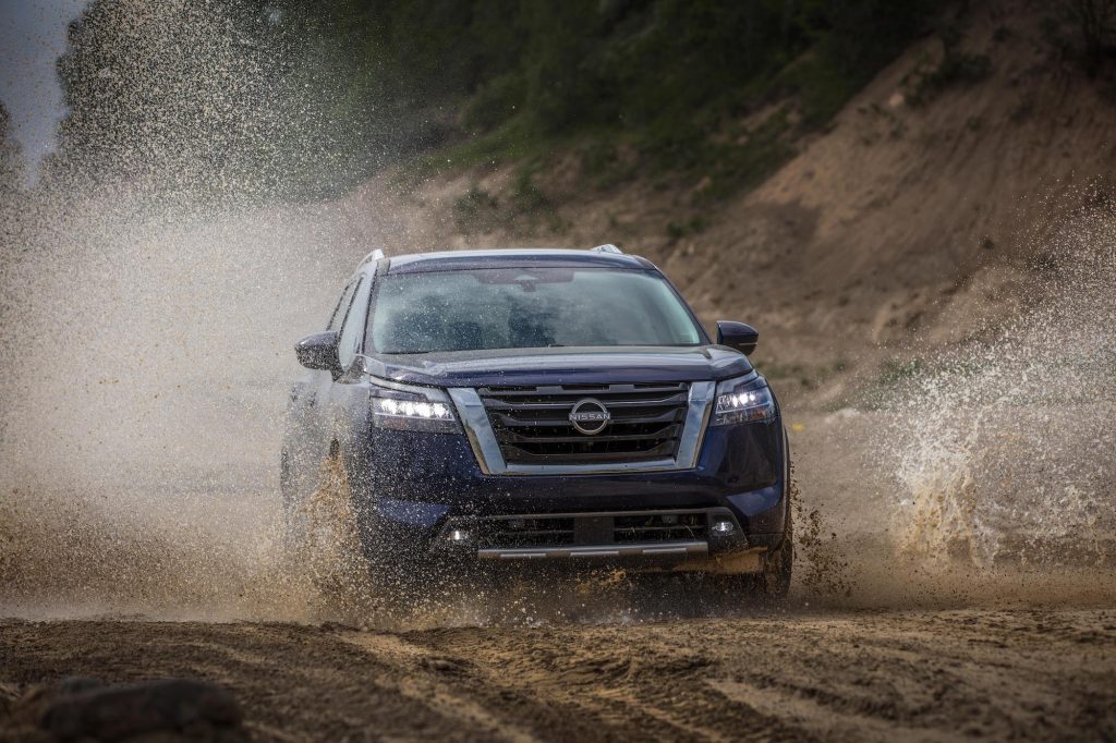 The all-new 2022 Nissan Pathfinder splashing through a puddle.