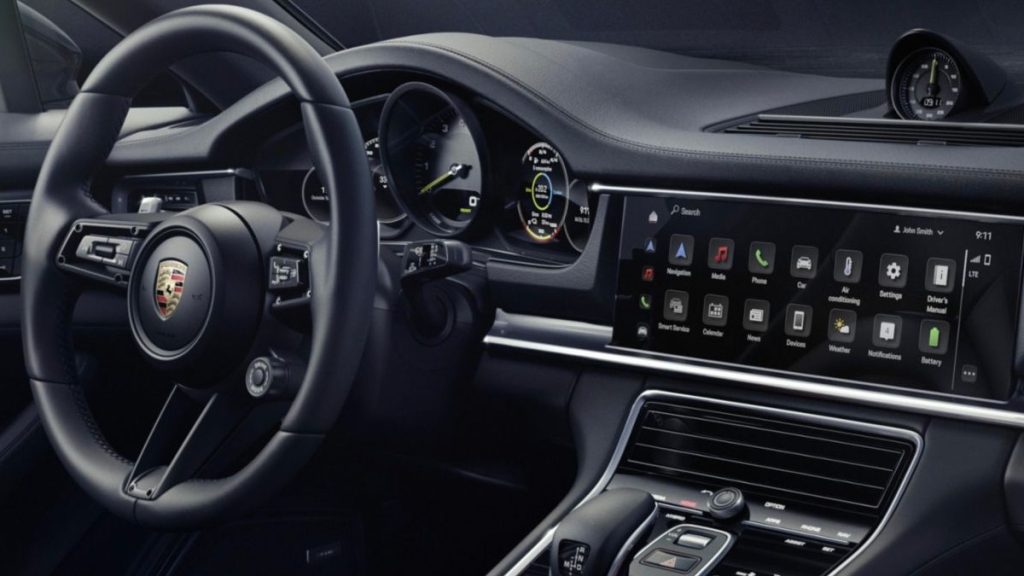 the interior of a new 2022 Porsche Panamera 4 E-Hybrid Platinum Edition showing off the high-res touch screen, leather steering wheel, and refined design