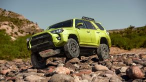 2022 Toyota 4Runner TRD Pro midsize off-road SUV in Lime climbing over rocks