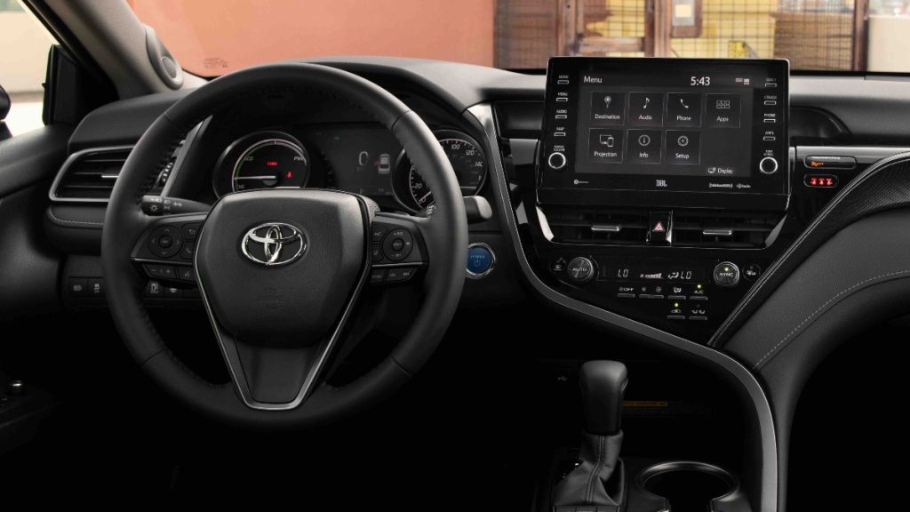 The interior of a new 2022 Toyota Camry Hybrid showing off the advanced technology and dual-zone climate controls
