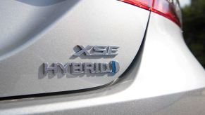2022 Toyota Camry Hybrid XSE midsize sedan badging with a silver paint color option