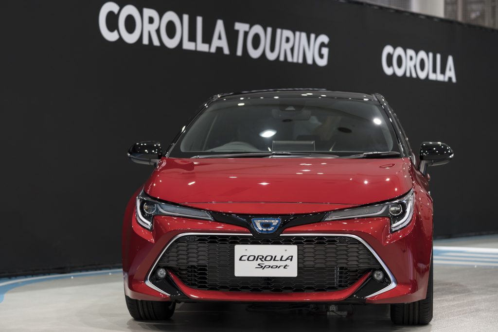 A Red Toyota Corolla Hatchback at an auto show