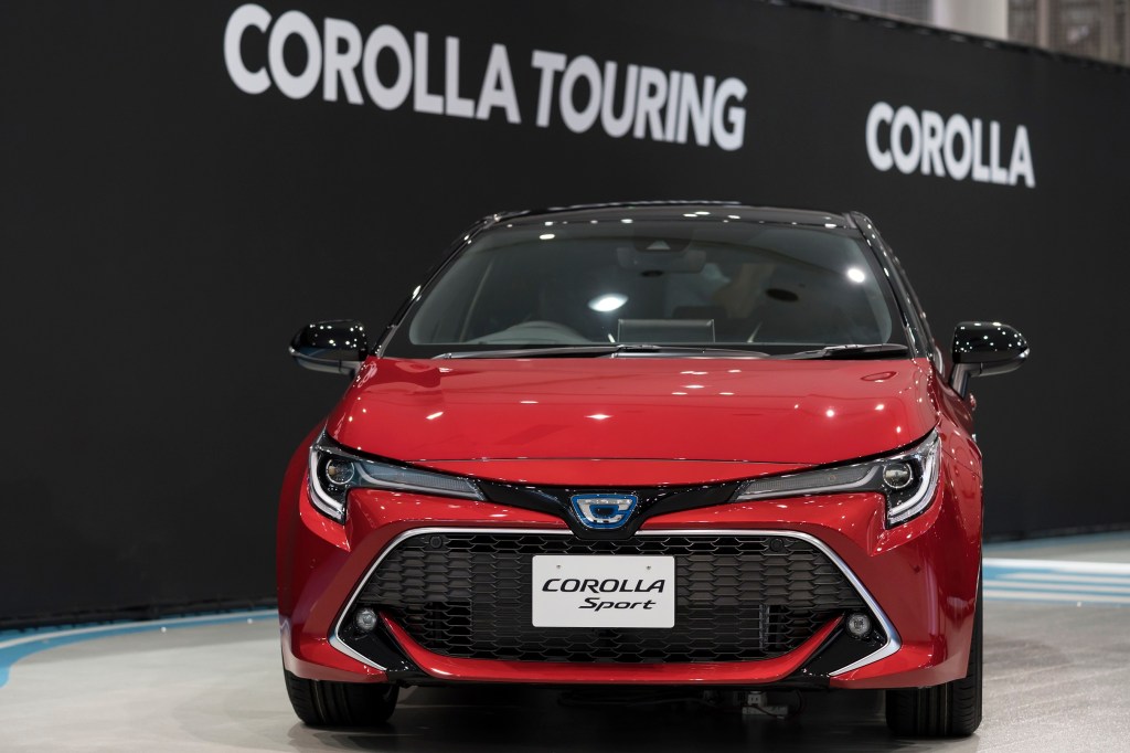 A Red Toyota Corolla Hatchback at an auto show