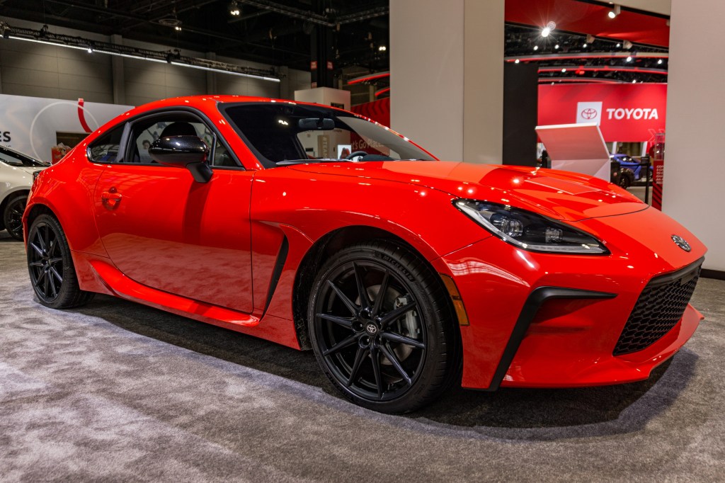 The front 3/4 view of a red 2022 Toyota GR86 at the 2022 Chicago Auto Show