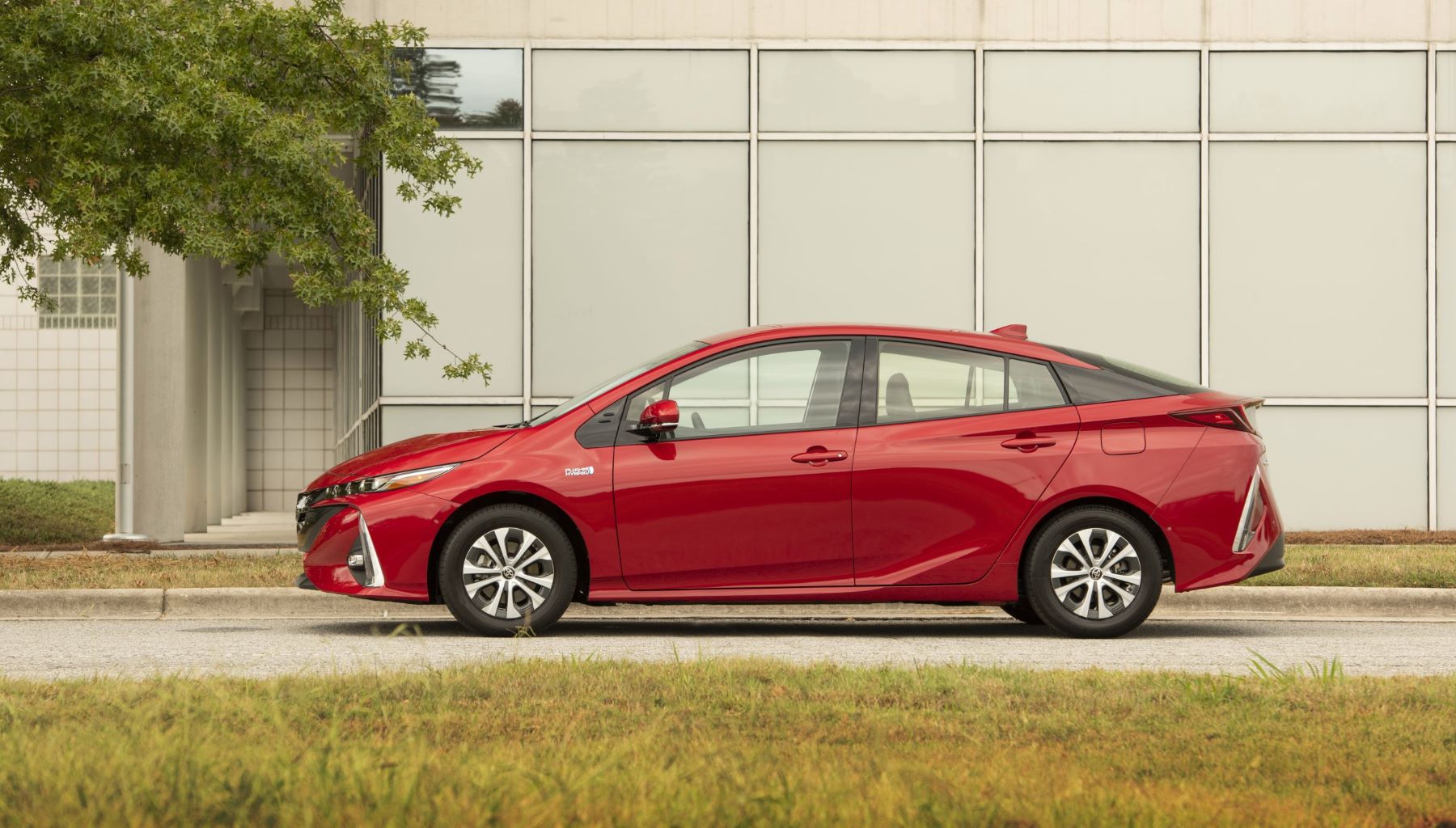 2022 Toyota Prius Prime plug-in hybrid hatchback side profile with a red color option