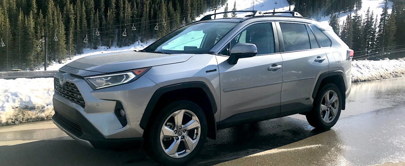 2022 Toyota RAV4 hybrid side view by a snow mountain