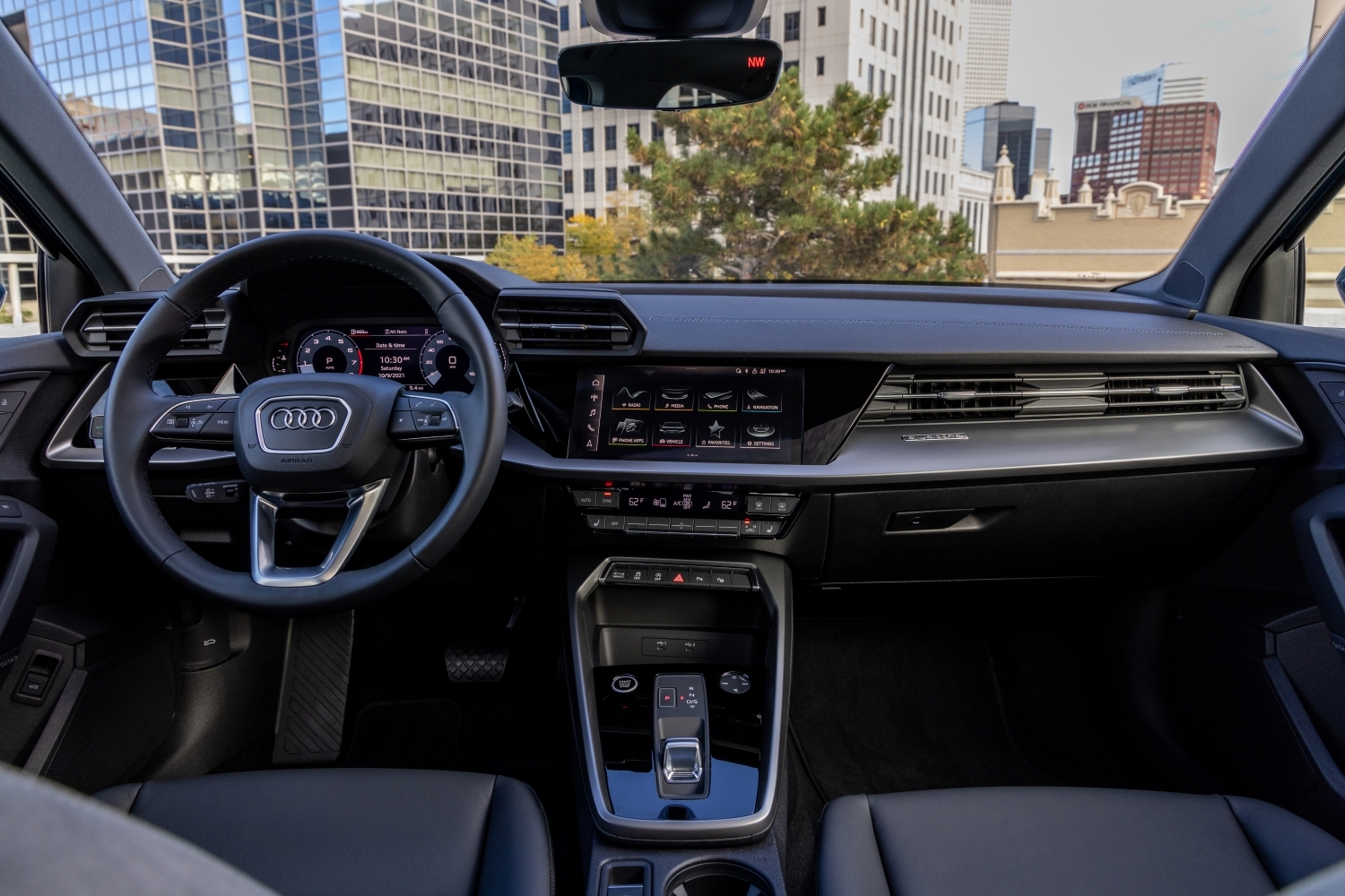 Interior shot of the 2022 Audi A3 sedan, showing the steering wheel, dashboard, infotainment system, and shifter