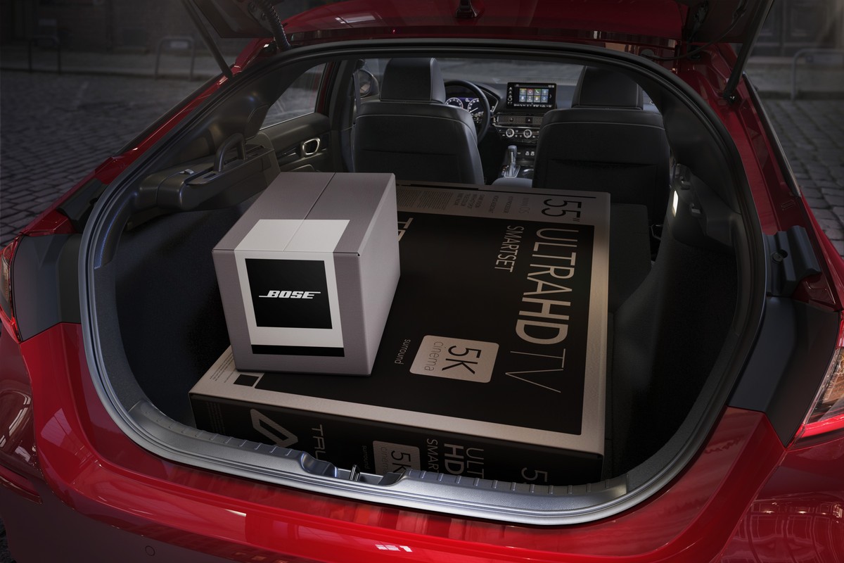 Interior look at cargo inside the trunk of the 2022 Honda Civic Hatchback. The rear seats are folded to allow for a big-screen TV box to fit easily