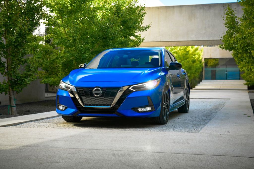 Front angle view of a blue 2022 Nissan Sentra parked on a concrete pad