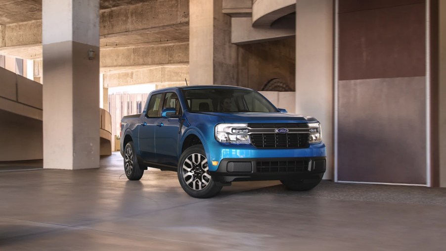 A blue 2022 Ford Maverick sits in a parking garage as a compact truck.