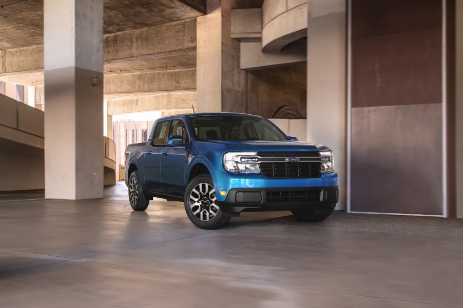 A blue Ford Maverick sits in a parking garage.
