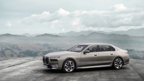 Driver side shot of the all-new 2023 BMW i7 Luxury EV Sedan in the mountains