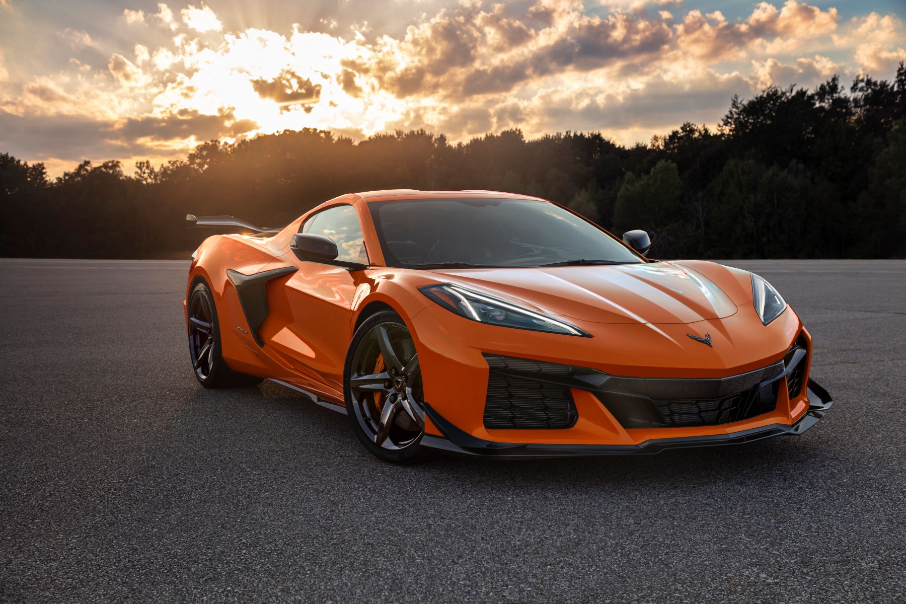 The 2023 Chevrolet Corvette Z06 luxury sports car model in orange parked under a bright sunset