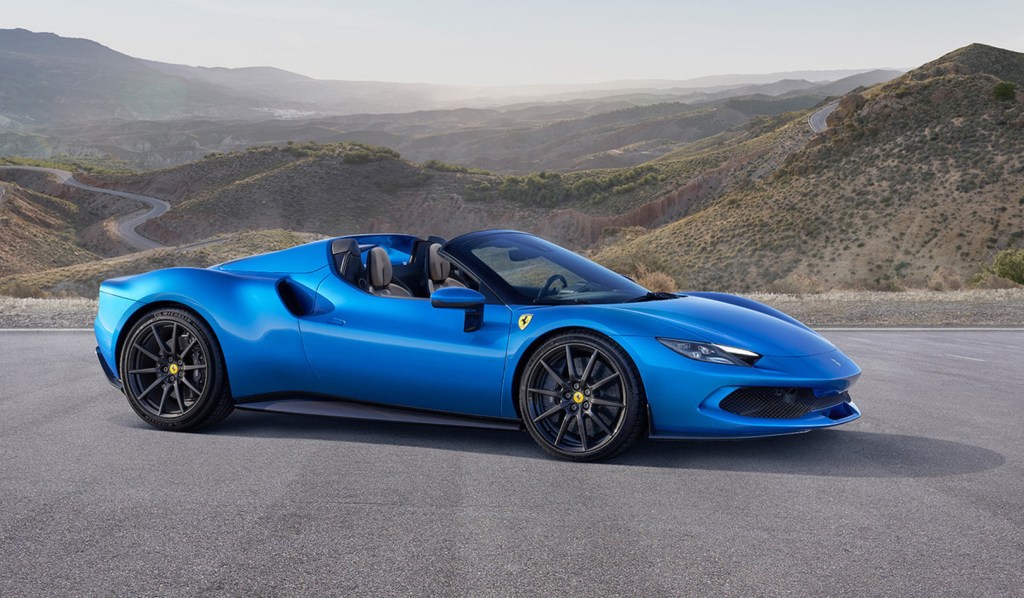 A blue 2023 Ferrari 296 GTS with its top down in the desert canyons