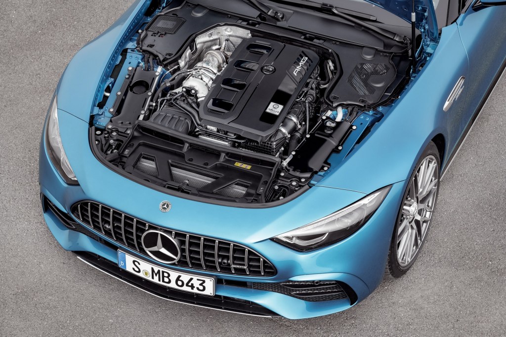 The open engine bay of a blue 2023 Mercedes-AMG SL 43 parked on pavement