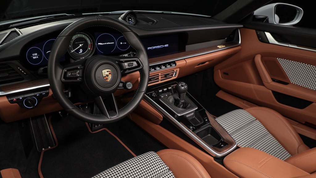 A 2023 Porsche 911 Sport Classic's nougat-leather seats with black-and-white-checkered inserts and black-and-nougat dashboard