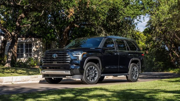 The 2023 Toyota Sequoia Limited full-size SUV parked on a driveway near a shaded lawn