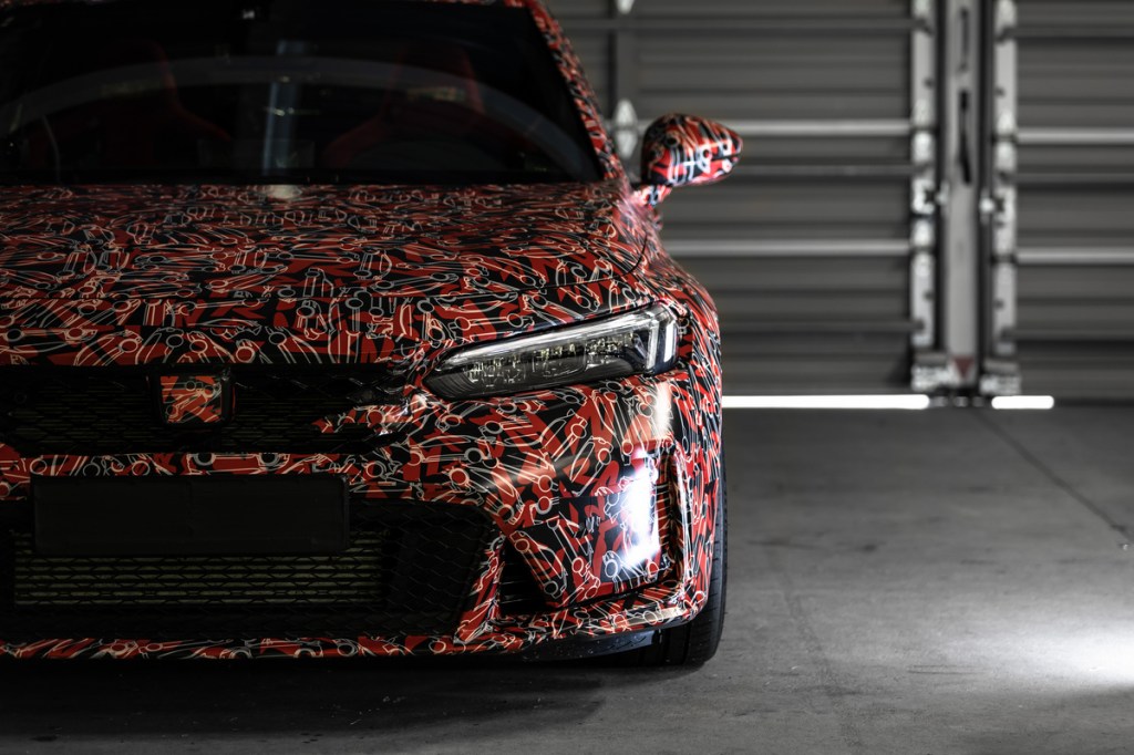 Close-up view of the front of a 2023 Honda Civic Type wearing camouflage