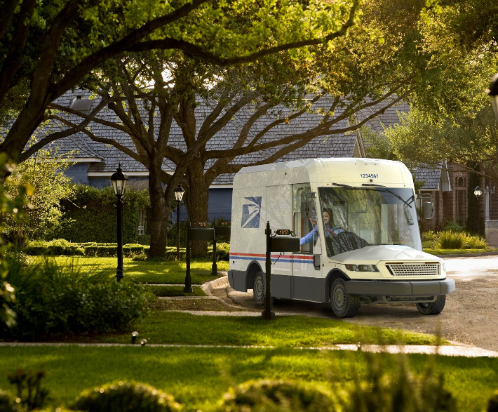 The next generation of USPS mail truck delivers a package, the Oshkosh NGDV.