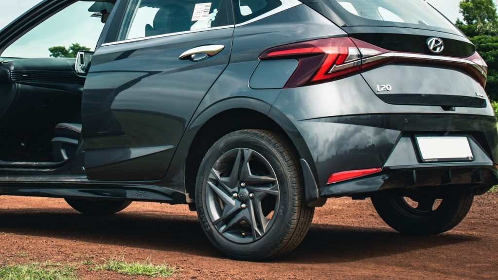 a hyundai wit four-lug wheels parked on a dirt road