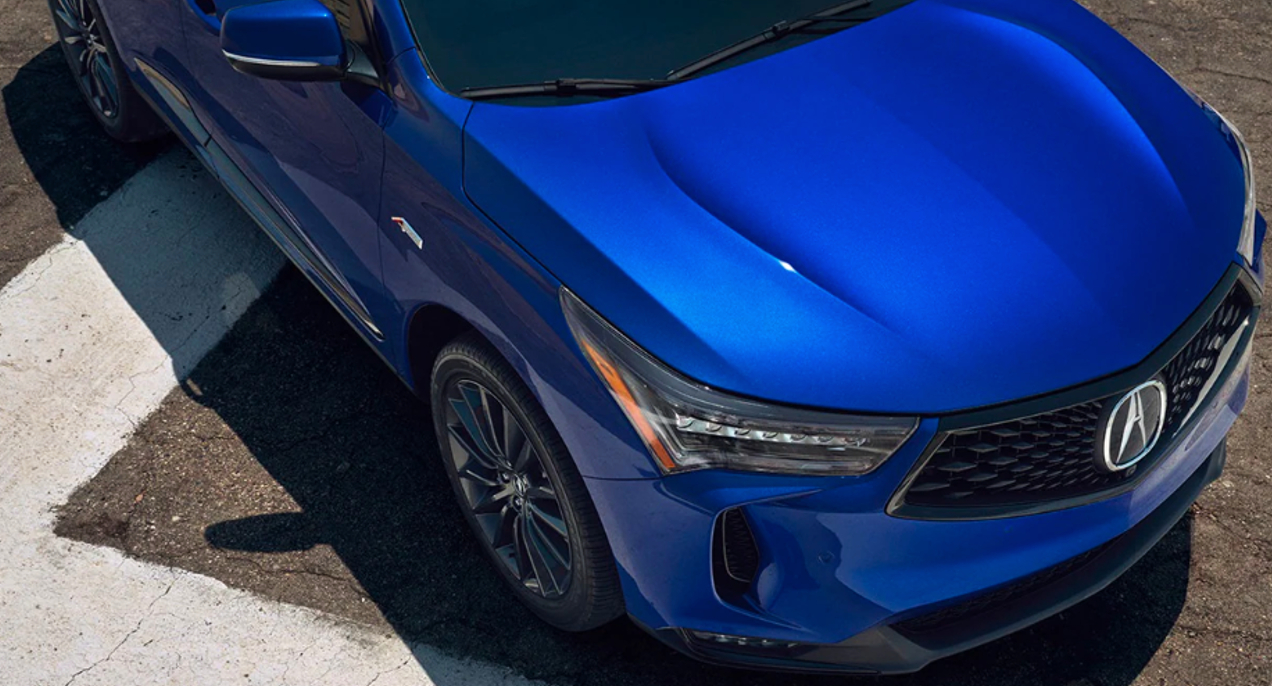 A blue 2022 Acura RDX small SUV is parked.