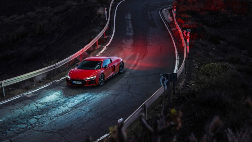 a red audi r8 v10 drives along a winding road at showing why this supercar is a great option for any drive