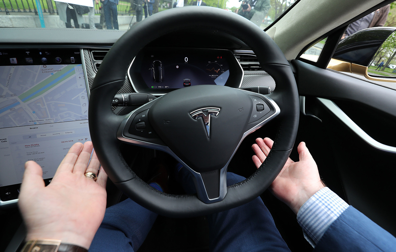 Dan Kiely, CEO of Voxpro, takes his hands off the wheel of his Tesla Model S car at a launch event for the MobilityX self-driving conference, a gathering of global autonomous vehicle leaders, in Dublin.