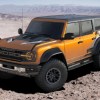 A yellow 2022 Ford Bronco Raptor in the desert.