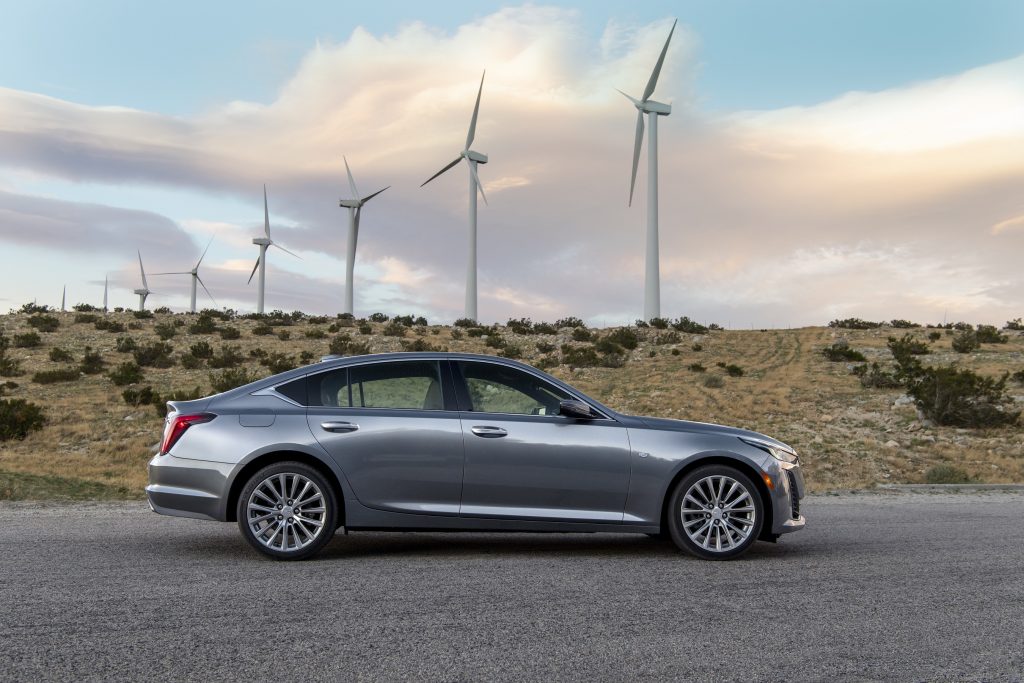 Silver Cadillac CT5 with windmills 