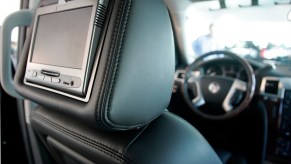 A leather car seat headrest with a built in TV screen