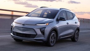 A gray 2022 Chevy Bolt EUV electric SUV is driving on the road.