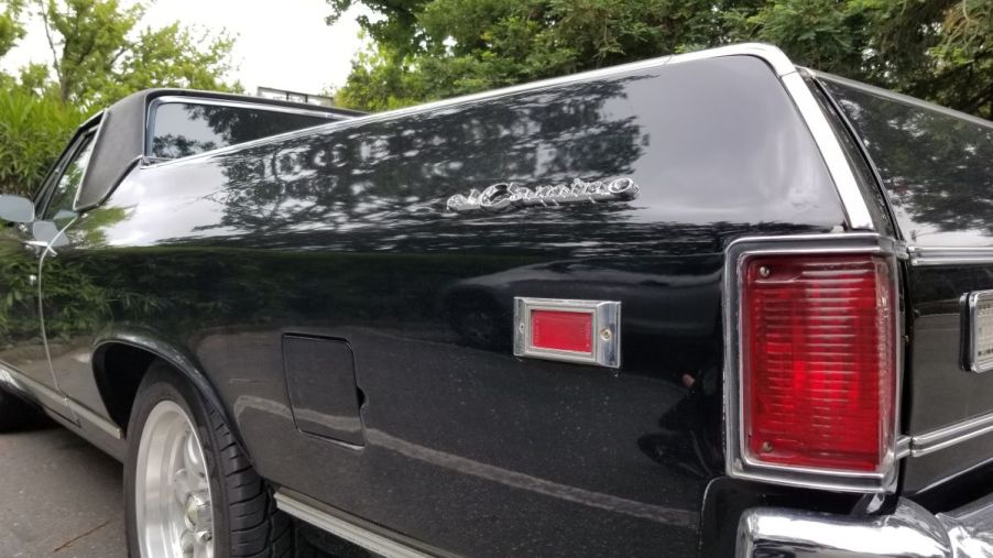 A black back end of a Chevy El Camino that is a coupe utility ute versus a pickup truck.