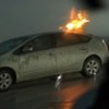 Close-up view of silver Toyota Prius struck by a bolt of lightning