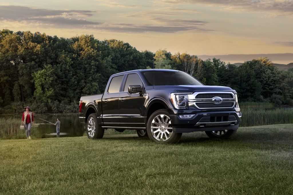 Dark blue 2022 Ford F-150, which has a quiet cab according to Consumer Reports, parked near a pond
