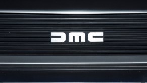Closeup of the DeLorean Motor Company (DMC) logo on an iconic DMC-12 grille