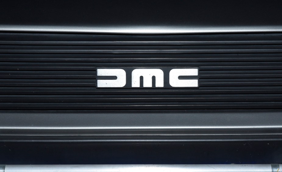 Closeup of the DeLorean Motor Company (DMC) logo on an iconic DMC-12 grille