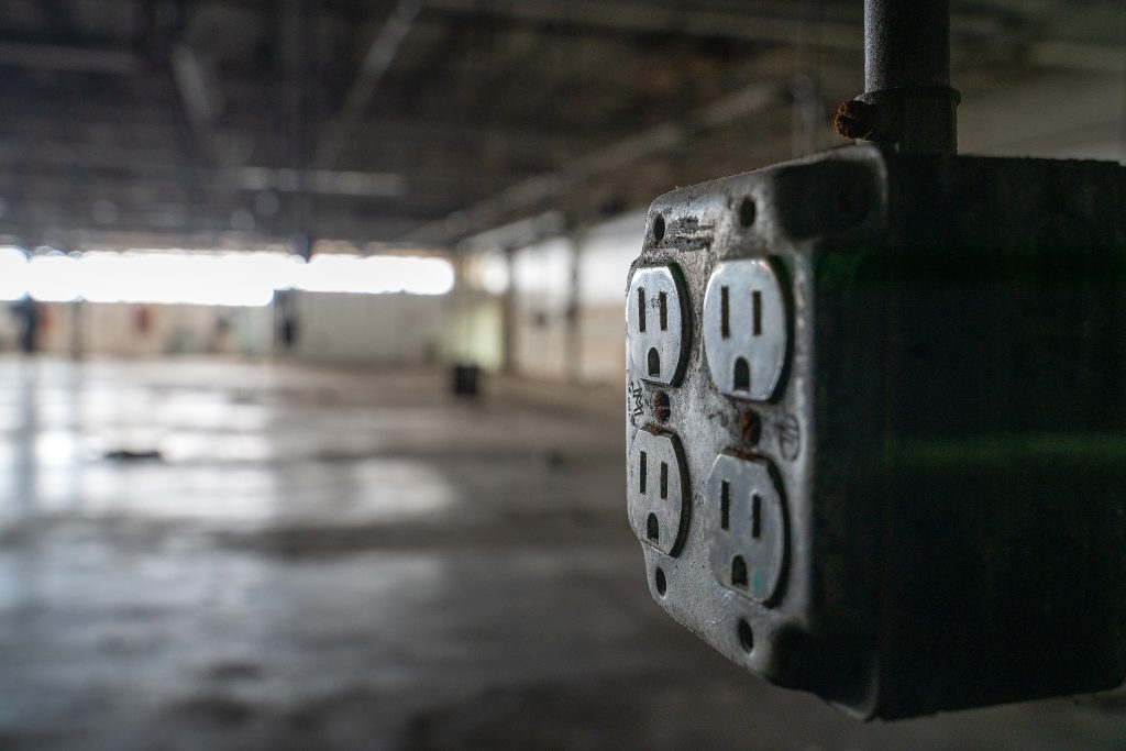 An electrical outlet inside an empty warehouse.