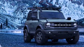 A green Ford Bronco small SUV is parked.