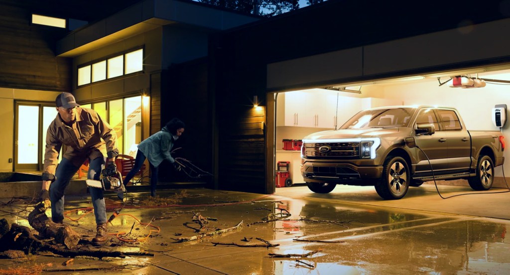 A gray 2022 Ford F-150 Lightning electric pickup truck is powering a home with Intelligent Backup Power.