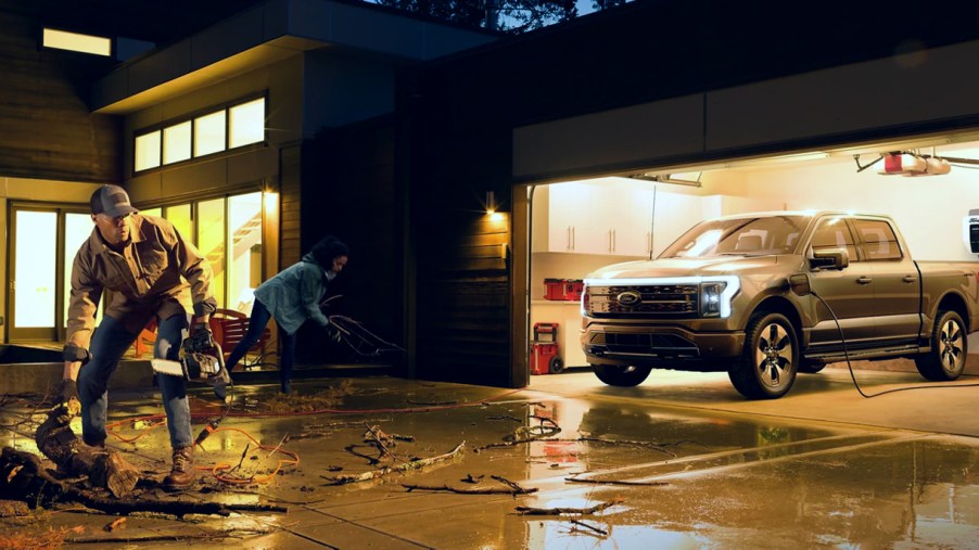 A gray 2022 Ford F-150 Lightning electric pickup truck is powering a home with Intelligent Backup Power.