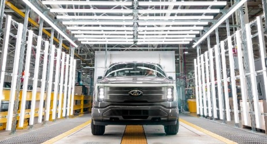 A gray Ford F-150 Lightning electric pickup from 2022 is parked.